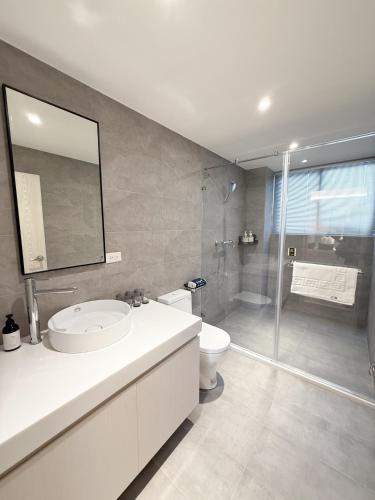 a bathroom with a sink and a toilet and a shower at 芭驛 8hundredmillion I 安平運河景觀住宿 in Anping