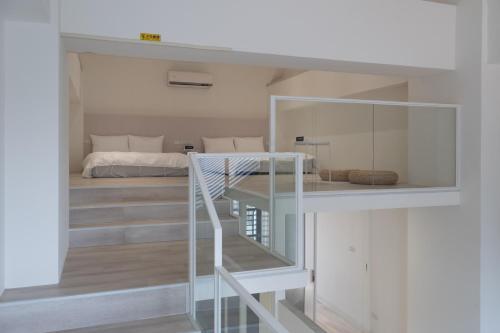 a room with a staircase leading to a bedroom at 芭驛 8hundredmillion I 安平運河景觀住宿 in Anping
