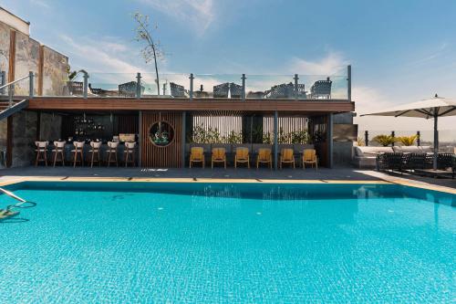 a large swimming pool with chairs and a restaurant at Baron Hotel Cairo in Cairo