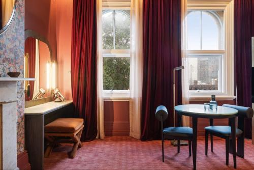 a room with a table and a window at Medusa Hotel Sydney in Sydney