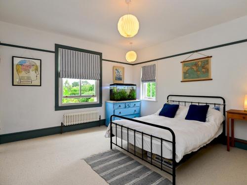 a bedroom with a bed and a tv in it at Pass the Keys 4-Bedroom Retreat in Radyr wLush Gardens Parking in Cardiff