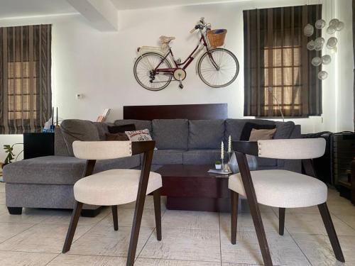 a living room with a couch and a bike on the wall at Dali Villa in Dhali