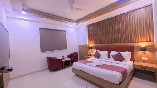 a hotel room with a bed and a flat screen tv at Hotel Almora BY The ELEVATE Group Near Delhi INTERNATIONAL Airport WIth- Free AIRPORT Pickup in New Delhi