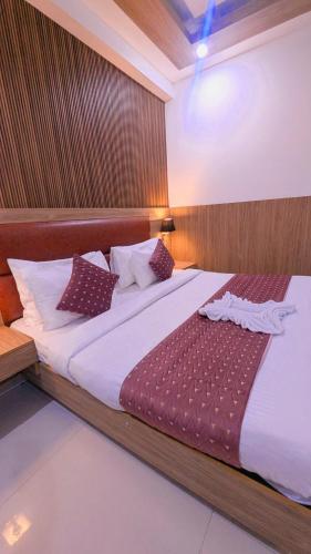 a bedroom with a large bed with white sheets at Hotel Almora BY The ELEVATE Group Near Delhi INTERNATIONAL Airport WIth- Free AIRPORT Pickup in New Delhi