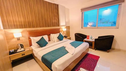 a hotel room with a bed and a desk and a window at Hotel Almora BY The ELEVATE Group Near Delhi INTERNATIONAL Airport WIth- Free AIRPORT Pickup in New Delhi