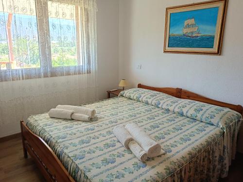 a bedroom with a bed with towels on it at Appartamento Luisa E in Villasimius