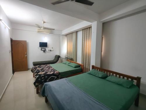 Ένα ή περισσότερα κρεβάτια σε δωμάτιο στο Green Garden Apartments
