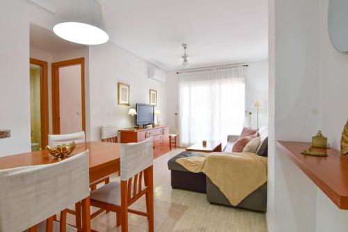 a living room with a table and a dining room at Magic Sunset View in El Borseral