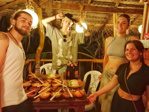 a group of people standing next to a table with food at Nature Rest Ashored in Sigiriya