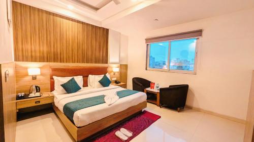 a bedroom with a bed and a desk and a window at Hotel Almora BY The ELEVATE Group Near Delhi INTERNATIONAL Airport WIth- Free AIRPORT Pickup in New Delhi