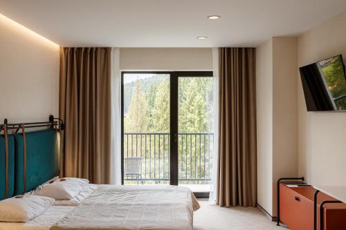 Postel nebo postele na pokoji v ubytování HVOYA Apart-Hotel & SPA