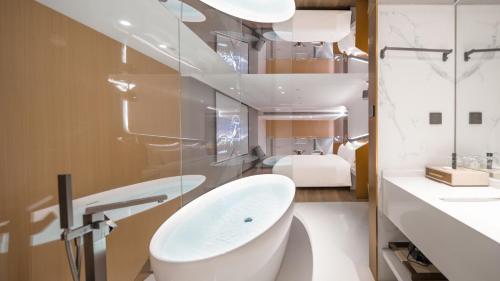 a white bathroom with a sink and a toilet at 重庆Indition英迪逊高空酒店 解放碑来福士店 in Chongqing