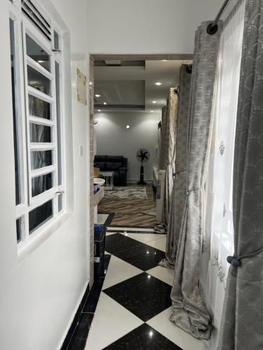 a hallway with a black and white checkered floor at Cnc bnb Kimana- 3bedroom in Gatunga