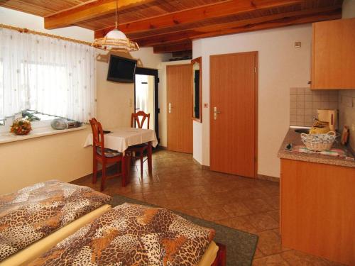 a room with a kitchen and a dining room with a table at Bungalow in Lübben with a terrace in Lübben
