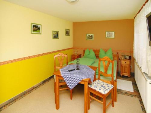 a room with a table and chairs and a couch at Bungalow in Lübben with a terrace in Lübben