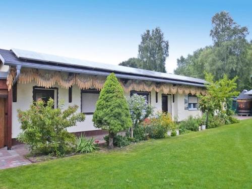 a house with a garden in front of it at Bungalow in Lübben with a terrace in Lübben