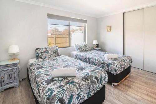a bedroom with two beds and a window at The Foxes Den- secure yard, WIFI in Geographe
