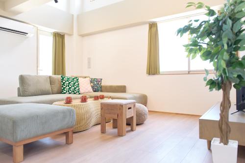 a living room with a couch and a table at Liberty Place Nakano by Tranova in Tokyo