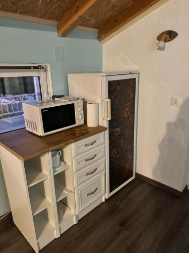 a microwave sitting on top of a counter with a kitchen at Kerch Apartments in Radovići