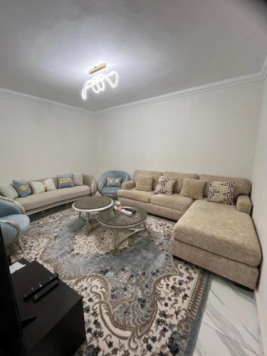 a living room with a couch and a table at Villa Kenan in King Mariout