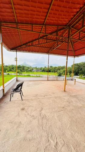 a bench sitting under a pavilion with a large roof at RKS- The Studio Farm in Valap