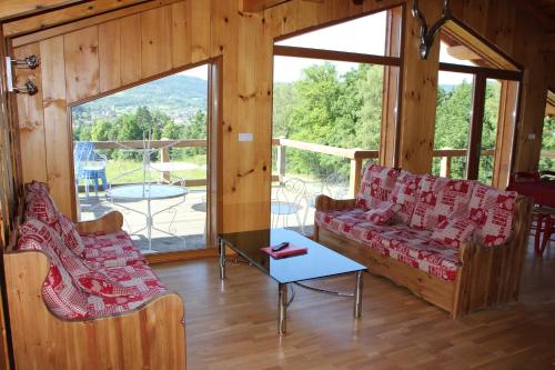 a living room with a couch and a table at Chalets Julien in Le Thillot