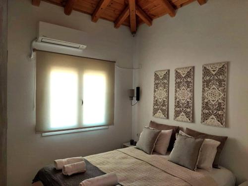 a bedroom with a large bed and a window at Maya 2, 2 bedroomed apartment on first floor in Skiathos Town