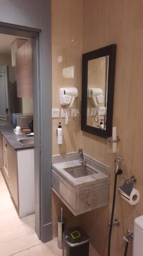 a bathroom with a sink and a mirror at Gazala Hotel in Riyadh
