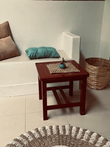 a coffee table in a living room with a couch at Rising Sun Bungalows in Gili Meno