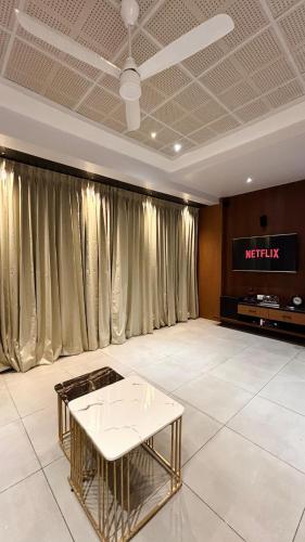 a living room with a table and a television at Sumadhu Homes 501 in Kolhapur