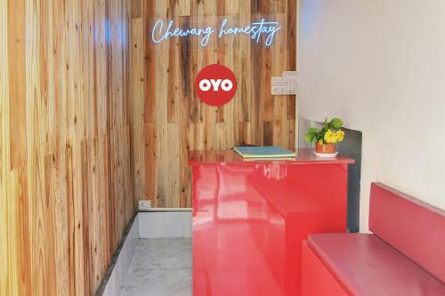 a red counter with a sign on a wooden wall at Hotel O Chewang Homestay in Darjeeling