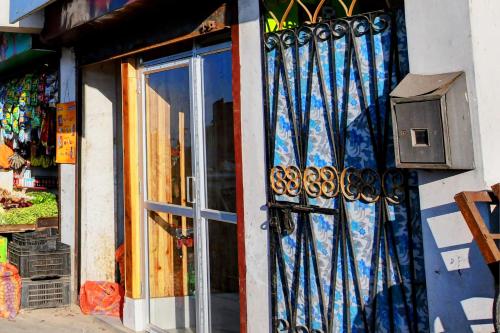 a door to a store with blue curtains on it at Hotel O Chewang Homestay in Darjeeling