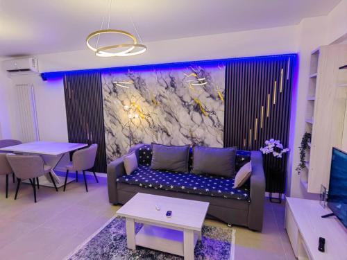 a living room with a couch and a table at Alezzi Odyssey in Mamaia Nord