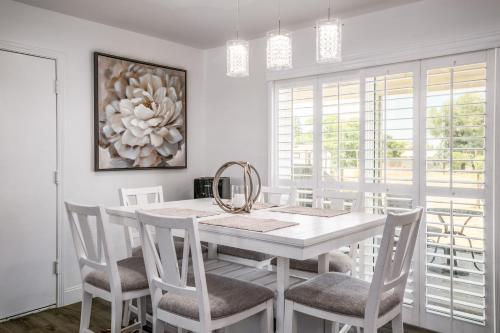 a white dining room with a white table and chairs at Remodeled 1 Acre Ranch Home in Madera in Madera