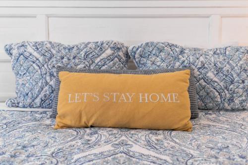 a pillow that says let s stay home on a bed at Remodeled 1 Acre Ranch Home in Madera in Madera