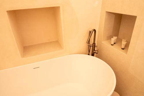 a bathroom with a white toilet in a room at Tinè Bed & Relax in Gioia del Colle