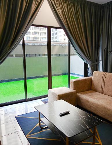 a living room with a couch and a coffee table at Studio with Rooftop Pool at Youth City Nilai by D'KAY HOMES, near USIM KLIA in Nilai