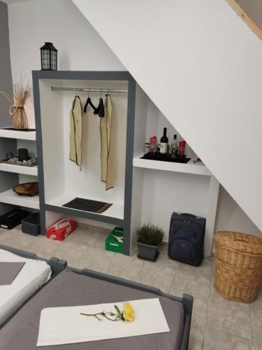 a room with a clothes rack in a attic at Petite Economy Lodge in Skiathos