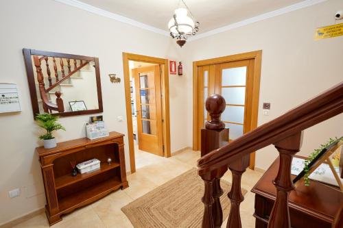 a hallway with a staircase and a mirror at Hevres El Capricho in Málaga