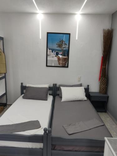 two beds sitting next to each other in a room at Petite Economy Lodge in Skiathos