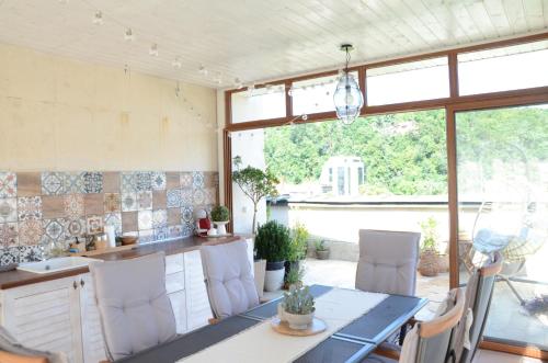a kitchen with a table and chairs in a room at Premier Luxury Apartment Center Gabrovo in Gabrovo