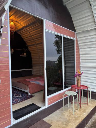 a room with a window with a bed and a table at Laa Cabana Lombok Glamping in Sapit