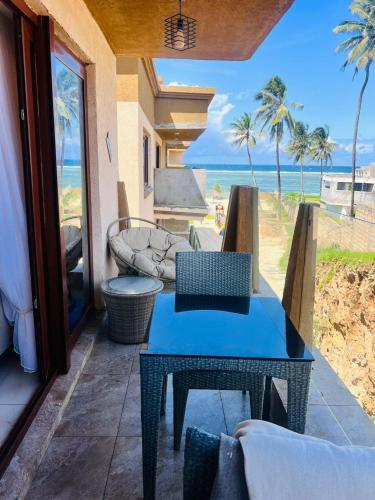a room with a table and a view of the beach at Sandy shores in Kilifi