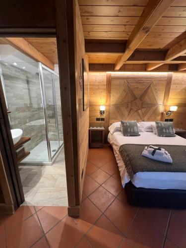 a bedroom with a bed in a room with wooden ceilings at B&B Nonna Ila in Courmayeur