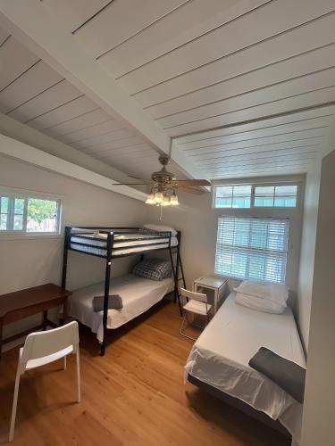 a bedroom with two bunk beds and a ceiling fan at Olive Startup House in Palo Alto