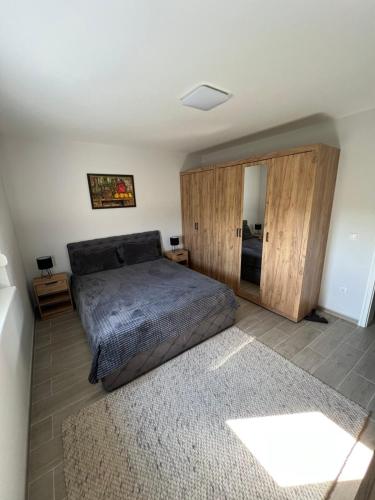 a bedroom with a large bed and a mirror at Villa Star Lux Bijeljina in Bijeljina