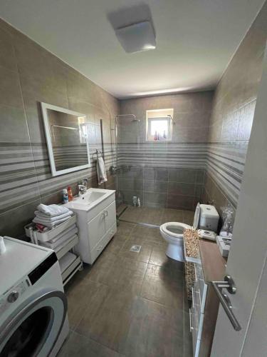 a bathroom with a toilet and a sink at Villa Star Lux Bijeljina in Bijeljina