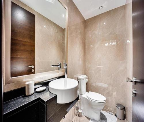 a bathroom with a toilet and a sink and a mirror at Hotel HiLiX Near Delhi Airport in New Delhi