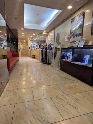a lobby of a store with a large tile floor at Hotel Listel Shinjuku in Tokyo