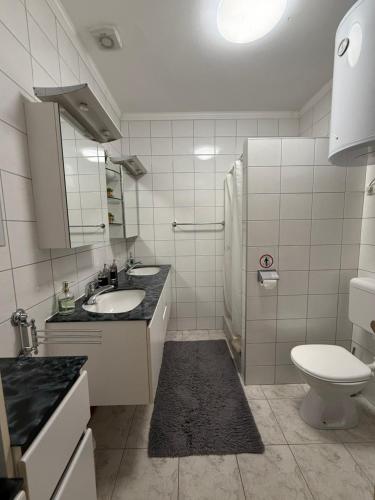 a white bathroom with a sink and a toilet at Villa Janja in Šilo